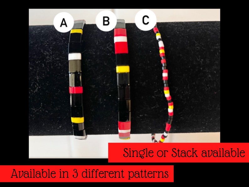 May include: Three different styles of black, red, white, and yellow beaded bracelets. The bracelets are labeled A, B, and C. Single or stack available. Available in 3 different patterns.