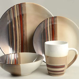 May include: A four-piece dinnerware set featuring a large plate, a smaller plate, a bowl, and a mug. The plates and mug have vertical stripes in shades of brown, beige, and red. The bowl is split into two colors, brown and beige.