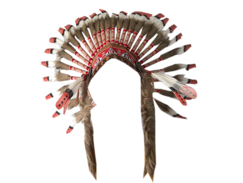 May include: A brown and red Native American headdress with feathers. The headdress has a beaded band with a geometric pattern.