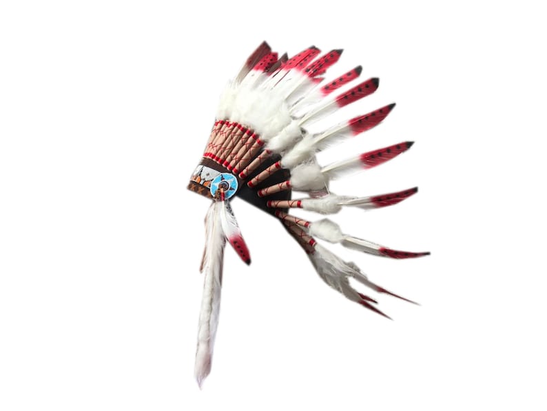 May include: A white and red feathered headdress with a brown base. The headdress has a blue and white beaded design.