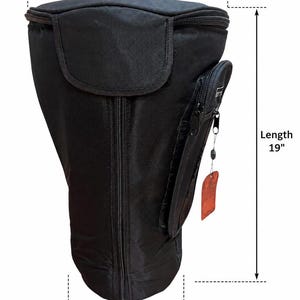 May include: Black padded drum bag with a top diameter of 12 inches, a length of 19 inches, and a bottom diameter of 8 inches. Features a zippered main compartment, a front pocket, and a tag.