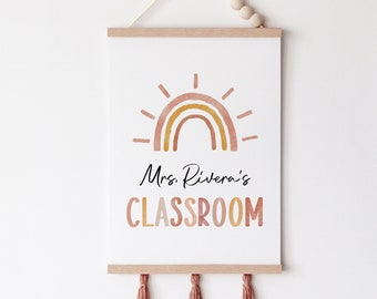 May include: A classroom sign with a watercolor rainbow and sun design. The text reads "Mrs. Rivera's CLASSROOM".