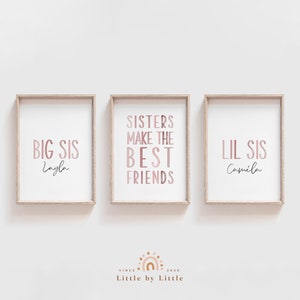 May include: Three framed prints with pink and white text. The left print says "BIG SIS Layla". The middle print says "SISTERS MAKE THE BEST FRIENDS". The right print says "LIL SIS Camila".