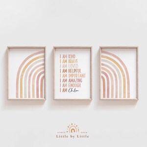 May include: Three framed prints with watercolor rainbows in shades of pink, orange, and yellow. The middle print features the text "I am kind, I am brave, I am loved, I am helpful, I am important, I am amazing, I am enough, I am Chloe".