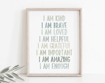 May include: A framed print with the words "I AM KIND, BRAVE, LOVED, HELPFUL, GRATEFUL, IMPORTANT, AMAZING, ENOUGH" in shades of green and blue. The print is in a light wood frame, suitable for a nursery or child's room.