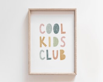 May include: A framed print with the text "COOL KIDS CLUB" in colorful, hand-drawn letters. The letters are in shades of pink, green, blue, and yellow.