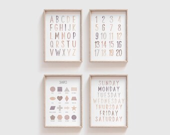 May include: Four framed prints with a neutral color palette. The prints feature the alphabet, numbers 1-20, shapes, and days of the week. The frames are light brown wood.