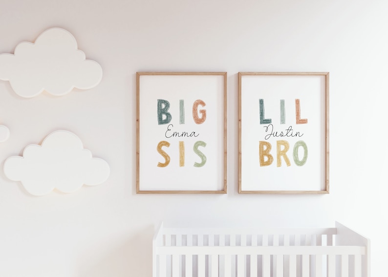 May include: Two framed prints with colorful text. The left print says "BIG SIS Emma" and the right print says "LIL BRO Justin".