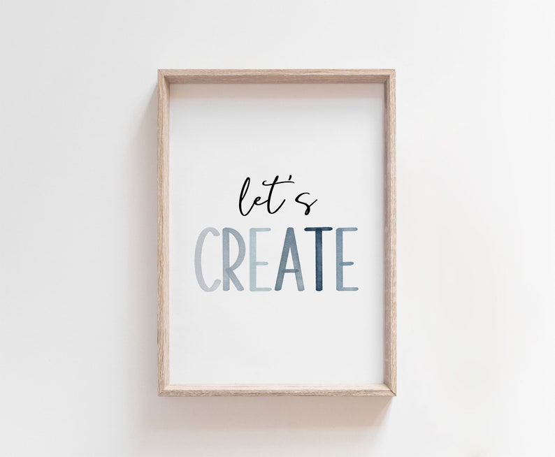 May include: A framed print with the text "let's CREATE" in a blue watercolor gradient. The text is in a modern, handwritten font.