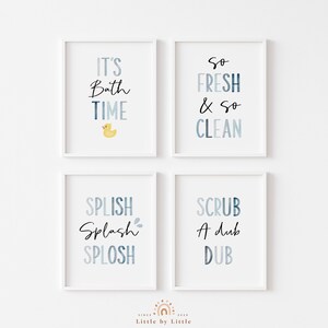 May include: Four white framed prints with blue and white watercolor backgrounds and black text. The prints read "It's Bath Time" with a yellow rubber duck, "So Fresh & So Clean", "Splish Splash Splosh", and "Scrub A Dub Dub".