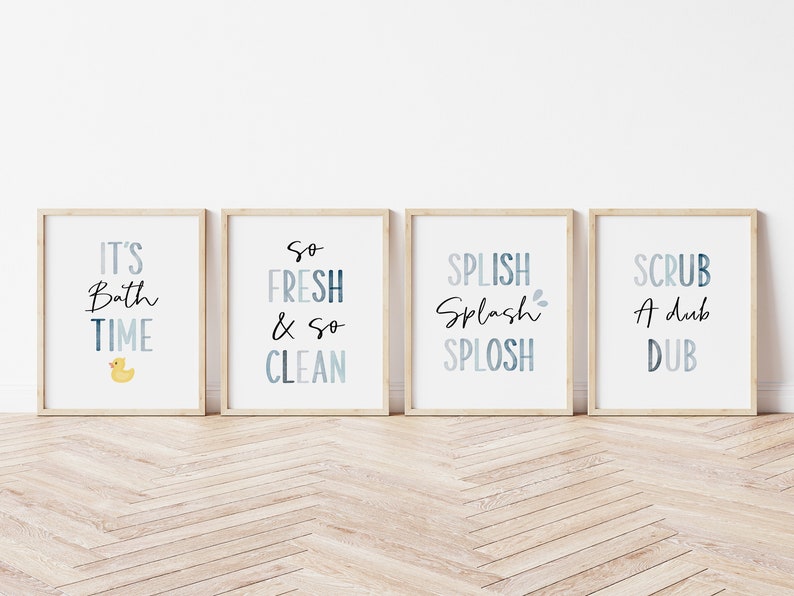 May include: Four framed prints with blue and white watercolor designs and black text. The prints read "It's Bath Time" with a yellow rubber duck, "So Fresh & So Clean", "Splish Splash Splosh", and "Scrub A Dub Dub".