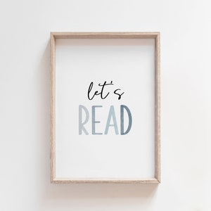 May include: A framed print with the text "let's read" in a blue gradient. The frame is light wood.