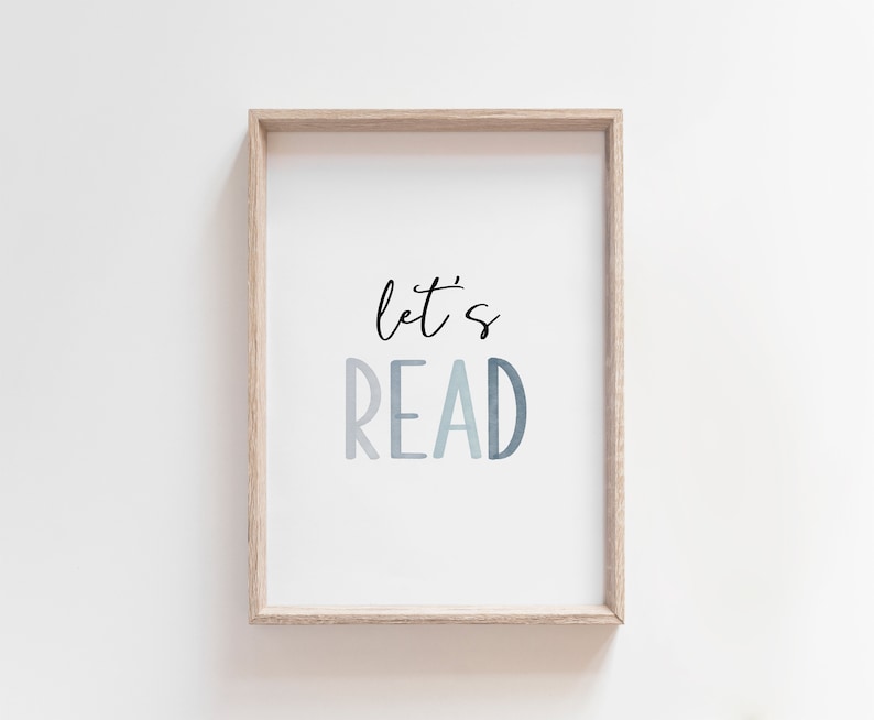 May include: A framed print with the text "let's read" in a blue gradient. The frame is light wood.
