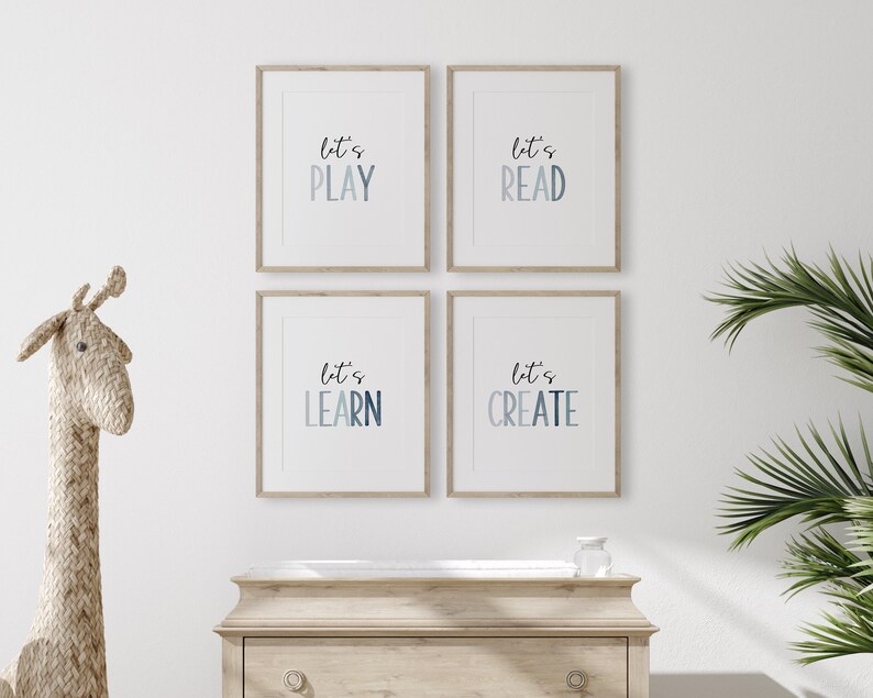May include: Four framed prints with a blue watercolor gradient background and white text. The prints read "Let's Play", "Let's Read", "Let's Learn", and "Let's Create".