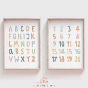 May include: Two framed prints with a white background. The left print features the alphabet in colorful, hand-drawn letters. The right print features the numbers 1 through 20 in colorful, hand-drawn numbers.