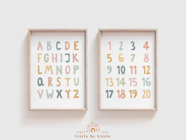 May include: Two framed prints with a white background. The left print features the alphabet in colorful, hand-drawn letters. The right print features the numbers 1 through 20 in colorful, hand-drawn numbers.