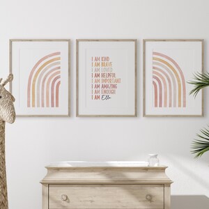 May include: Three framed prints with a watercolor rainbow design. The center print features the text "I am kind, I am brave, I am loved, I am helpful, I am important, I am amazing, I am enough, I am Ella".