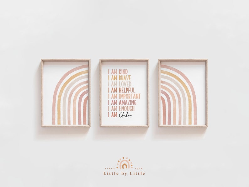 May include: Three framed prints with watercolor rainbows in shades of pink, orange, and yellow. The middle print features the text "I am kind, I am brave, I am loved, I am helpful, I am important, I am amazing, I am enough, I am Chloe".