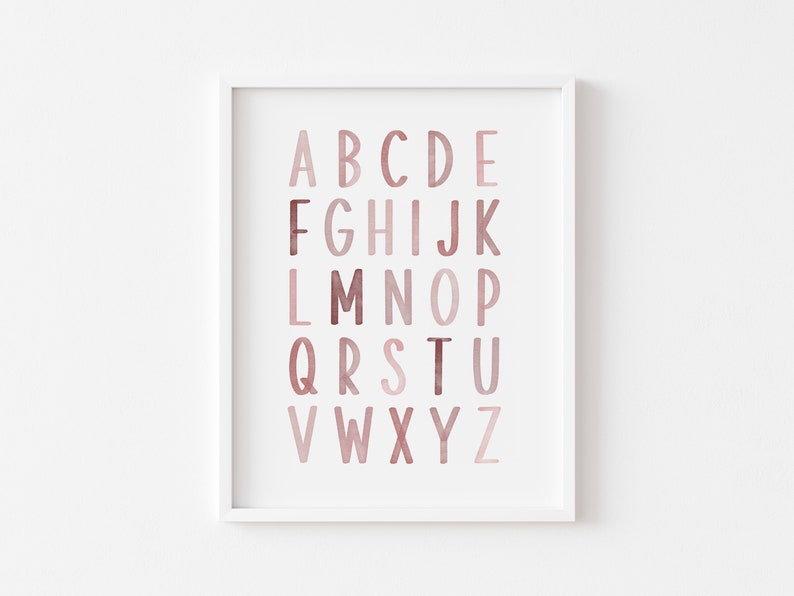 May include: A framed print of the alphabet in a pink and brown watercolor design. The letters are arranged in rows, with the first row being A-E, the second row being F-K, and so on.