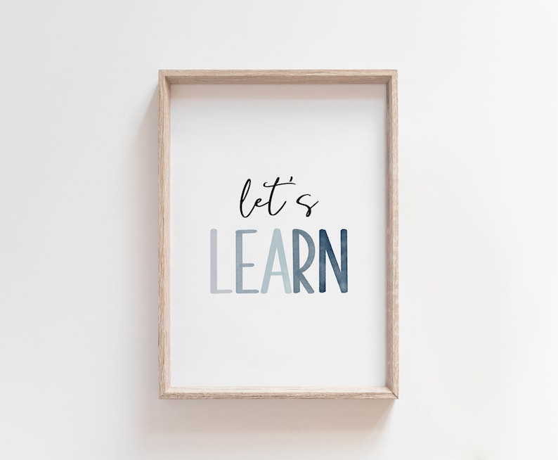 May include: A framed print with the text "let's learn" in a blue watercolor gradient. The frame is a light wood color.
