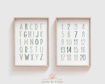 May include: Two framed prints with a white background. The print on the left shows the alphabet in a light green and gray color scheme. The print on the right shows the numbers 1 through 20 in the same color scheme.