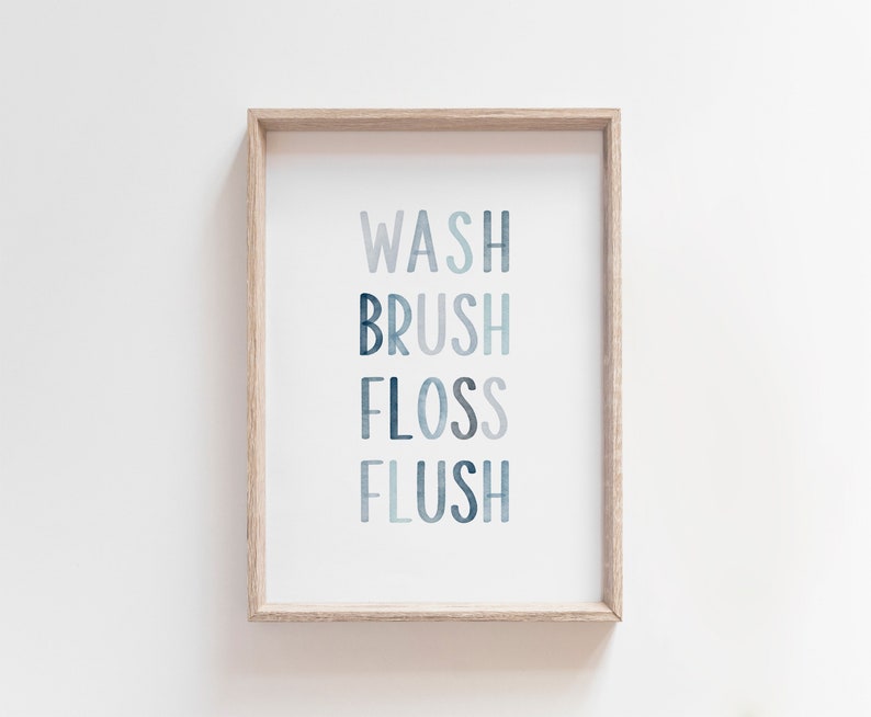 May include: A framed print with the words "WASH BRUSH FLOSS FLUSH" in a blue watercolor style.