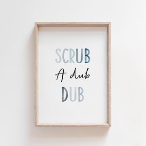 May include: A framed print with the text "SCRUB A DUB DUB" in a blue watercolor style.