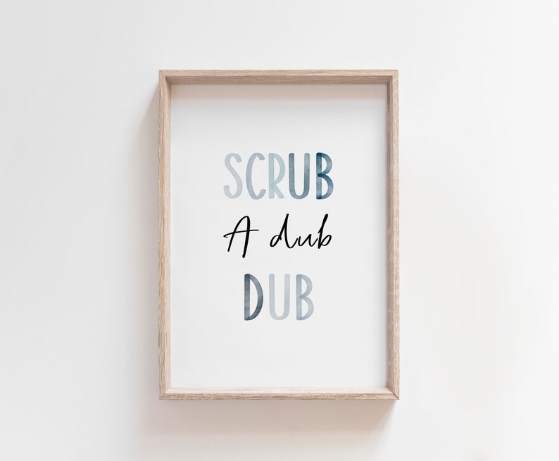 May include: A framed print with the text "SCRUB A DUB DUB" in a blue watercolor style.