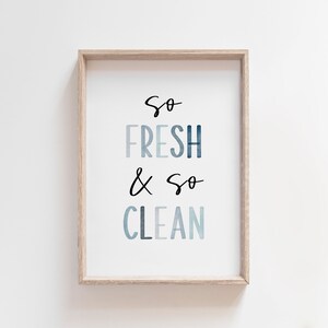 May include: A framed print with the text "So Fresh & So Clean" in a blue watercolor style.