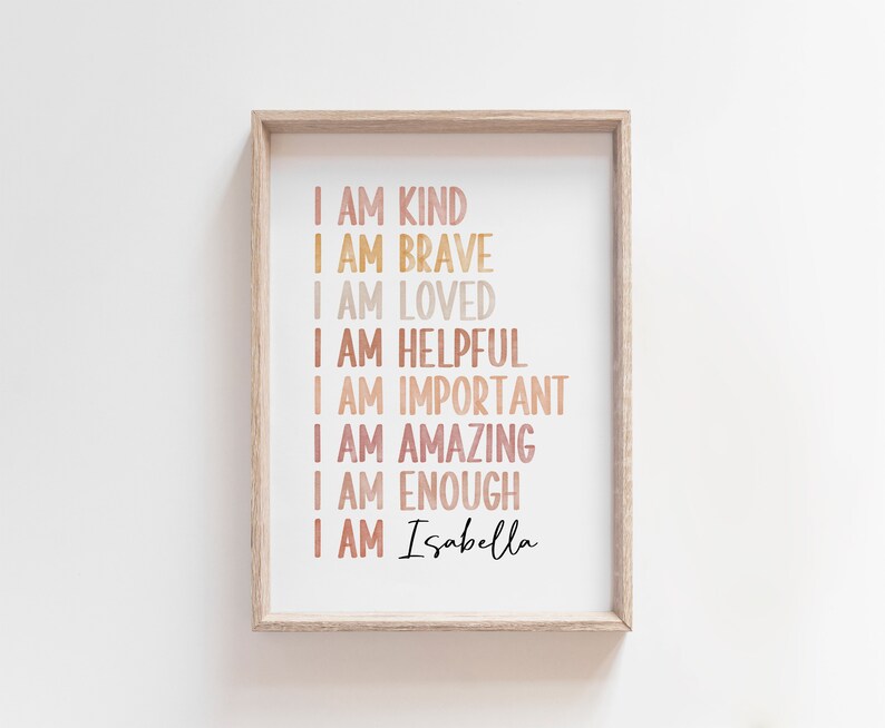 May include: A framed print with a white background and a list of positive affirmations in a rainbow gradient of colors. The text reads "I am kind, I am brave, I am loved, I am helpful, I am important, I am amazing, I am enough, I am Isabella".