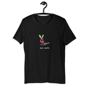 May include: Black t-shirt featuring a graphic of a beet wearing sunglasses and holding a DJ mixer. The text "sick beets" is printed below the graphic.