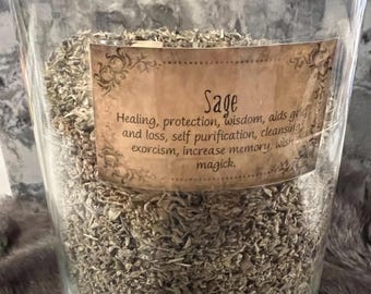 May include: A glass jar filled with dried sage leaves. The jar has a label that reads "Sage" and lists the benefits of sage, including healing, protection, wisdom, aids grief and loss, self purification, cleansing, exorcism, increase memory, wish magick.