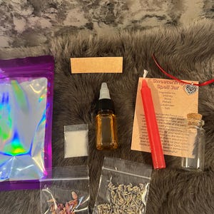 May include: A spell jar kit containing a red candle, a small glass bottle, a bag of white crystals, a bag of dried lavender, a bag of rose petals, and a small bottle of oil. The kit includes instructions for a sweetening spell.