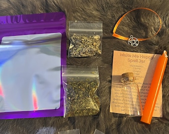 May include: A purple pouch, a small orange ribbon with a silver star charm, and several small bags containing herbs, crystals, and a small glass bottle. The text on the card reads "Make Me Happy Spell Jar".