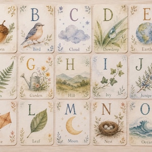 May include: A set of watercolour alphabet cards, each with a nature-themed illustration. The cards display letters A to O, with images of an acorn, bird, cloud, dewdrop, earth, fern, garden, hill, ivy, juniper, kite, leaf, moon, nest, and ocean.