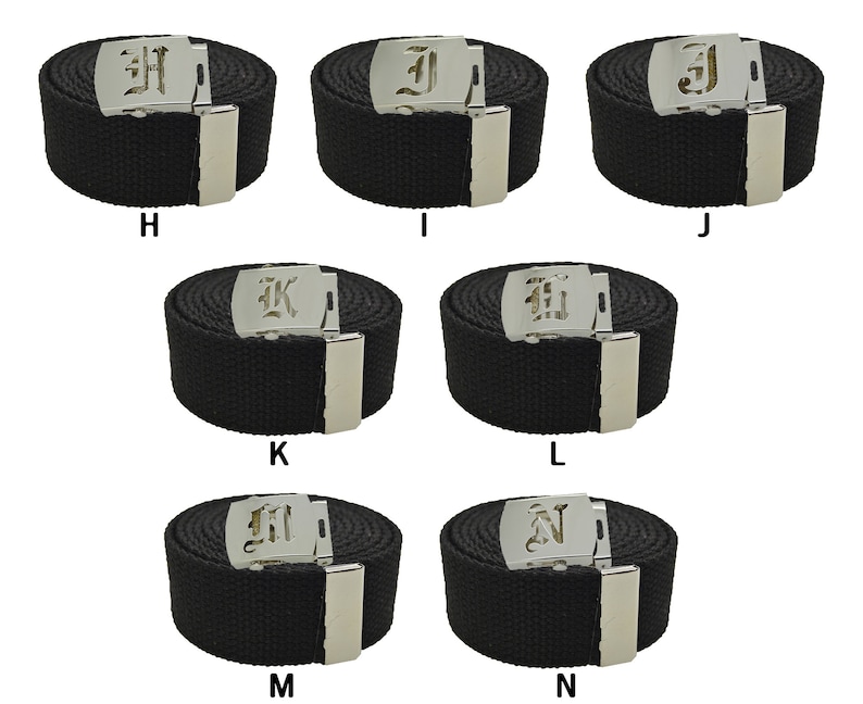 May include: Eight black canvas belts with silver buckles featuring a different letter of the alphabet on each buckle. The letters are in a gothic font.