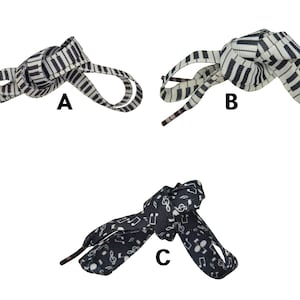 May include: Three pairs of shoelaces are displayed. Two pairs feature a piano key design in black and white. The third pair is black with white musical notes. Each pair is knotted to show the design.