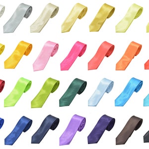 May include: A collection of 24 solid color satin ties in various colors, including white, silver, cream, gold, yellow, light green, pink, red, orange, light blue, dark blue, purple, brown, and black.