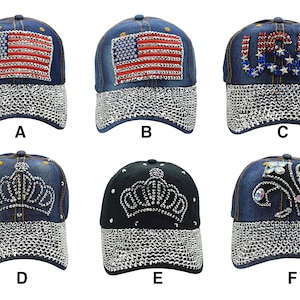 May include: Six denim baseball caps with different rhinestone designs. The caps are blue, black, and have a variety of designs including the American flag, the word "USA", a crown, and a fleur-de-lis.