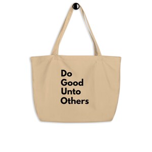 May include: Beige tote bag with black text that reads "Do Good Unto Others." The bag has long handles and is made of a soft, durable material. Perfect for carrying groceries, books, or everyday essentials.