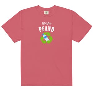 May include: A coral-colored t-shirt with the words "Hot for Pfand" above a recycling symbol with a water bottle inside. The shirt is made of a soft material and has short sleeves.