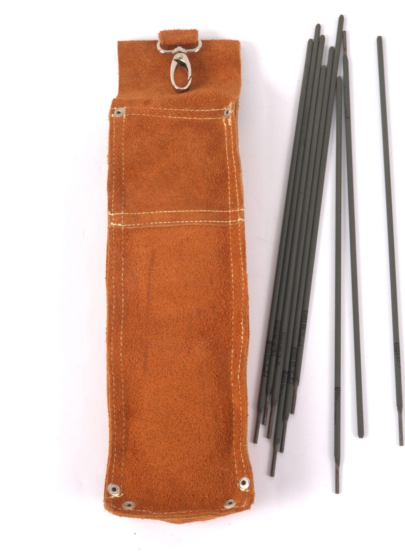 Leather Welding Rod Pouch | Handmade Welder Rod Holder,  A brown leather welding rod holder with a metal clasp, next to a bundle of gray welding rods. The holder has white stitching and metal rivets at the bottom.