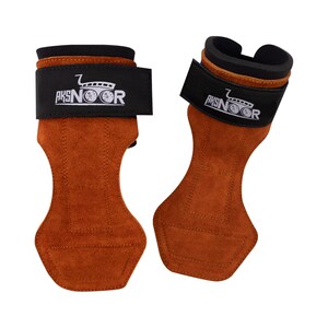May include: A pair of brown leather weightlifting grips with black wrist straps. The straps feature the text "AKSNOOR" and a logo. The grips are designed to protect hands during workouts and are made of a suede-like material.