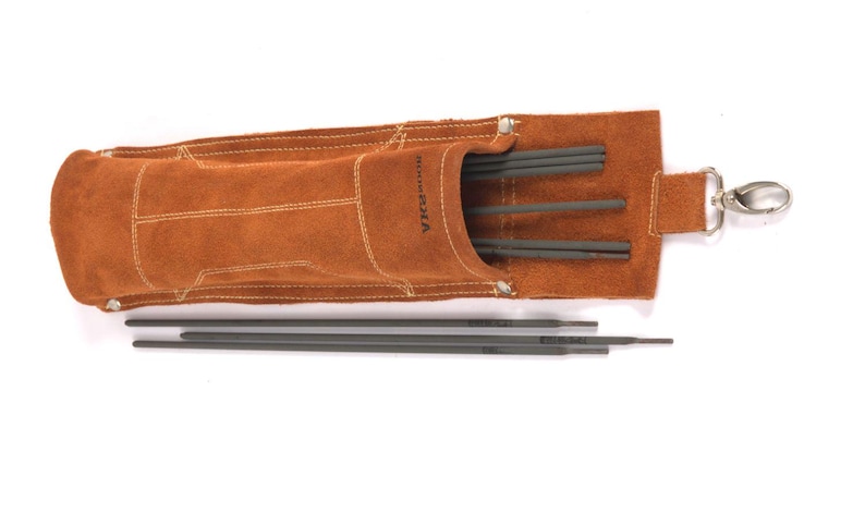 Leather Welding Rod Pouch | Handmade Welder Rod Holder. A brown leather tool pouch with a silver clasp, holding several dark gray welding rods. The pouch has white stitching and the brand name "Hanna Sola" is visible. Several rods are also outside the pouch.