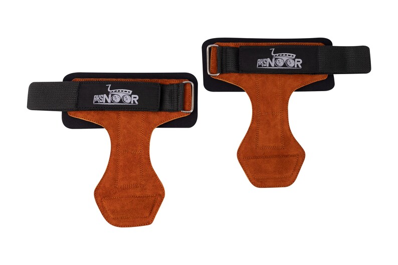 May include: Two weightlifting grips with brown leather palms and black wrist straps. The straps have a silver buckle and the text "AKSNOOR" in white. The grips are designed to protect hands during workouts.