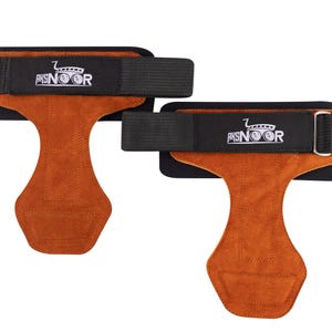 May include: A pair of brown leather weightlifting grips with black adjustable straps. The straps have the text "AKSNOR" printed on them.