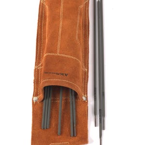 Leather Welding Rod Pouch | Handmade Welder Rod Holder brown leather tool pouch with a silver clasp, holding several dark gray welding rods. The pouch has the text "AKSNOOR" printed on it. The pouch is open, revealing the rods.
