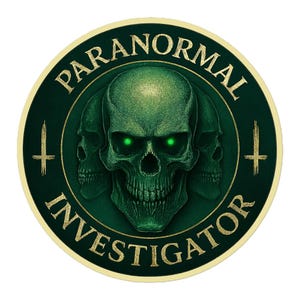 May include: A circular emblem with a green skull and two smaller skulls behind it. The skull has glowing green eyes. The words "PARANORMAL INVESTIGATOR" are written around the edge in gold lettering, with gold crosses on either side.