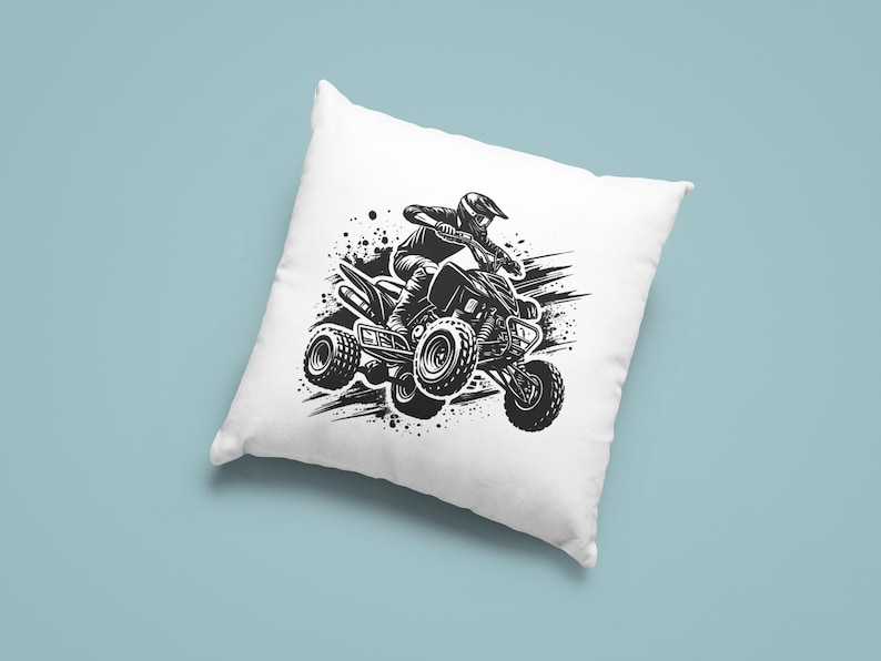 May include: Black and white illustration of a person riding an ATV on a dirt track. The ATV is in motion and the person is leaning into the turn. The image is on a white pillow.