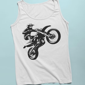 May include: A white tank top with a black silhouette of a motocross rider performing a wheelie on their dirt bike.